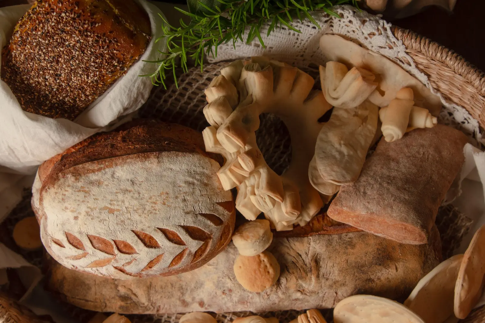 A basket of rustic bread loaves and rolls