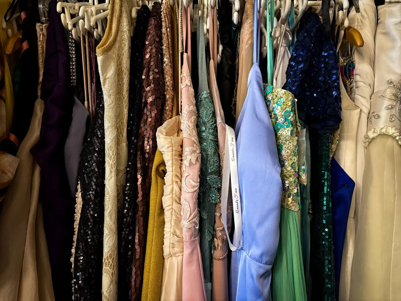 Evening dresses and sequinned gowns on a rail