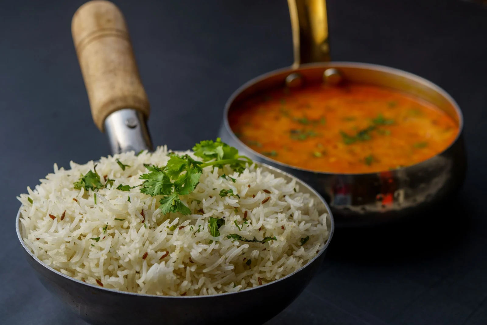 Dal and jeera rice in brass pans