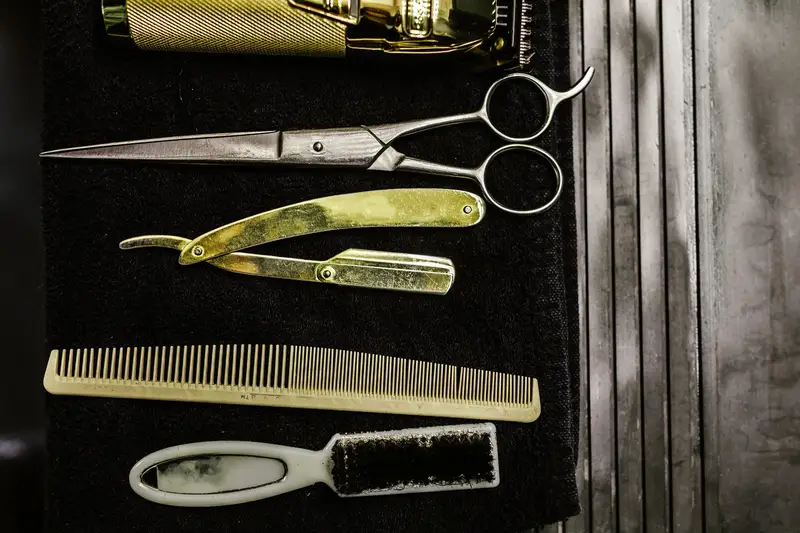 Barber scissors, a razor and combs on dark cloth