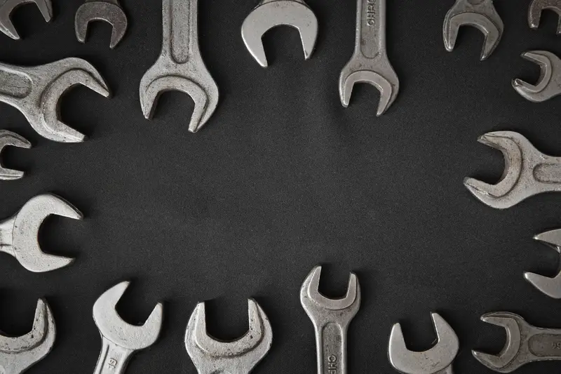 Spanners laid out in a circle on a dark surface