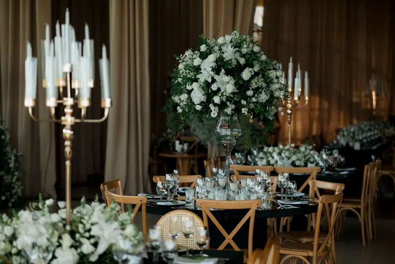 A candelabra and white flowers on a dinner table